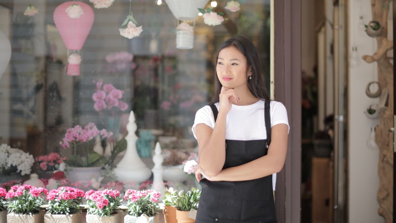 Local shop owner outside the storefront
