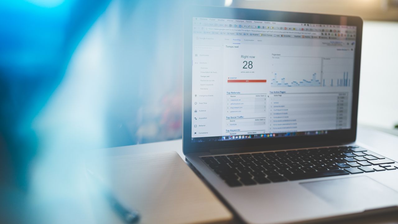 Small business reviewing SEO analytics on a laptop in a modern workspace
